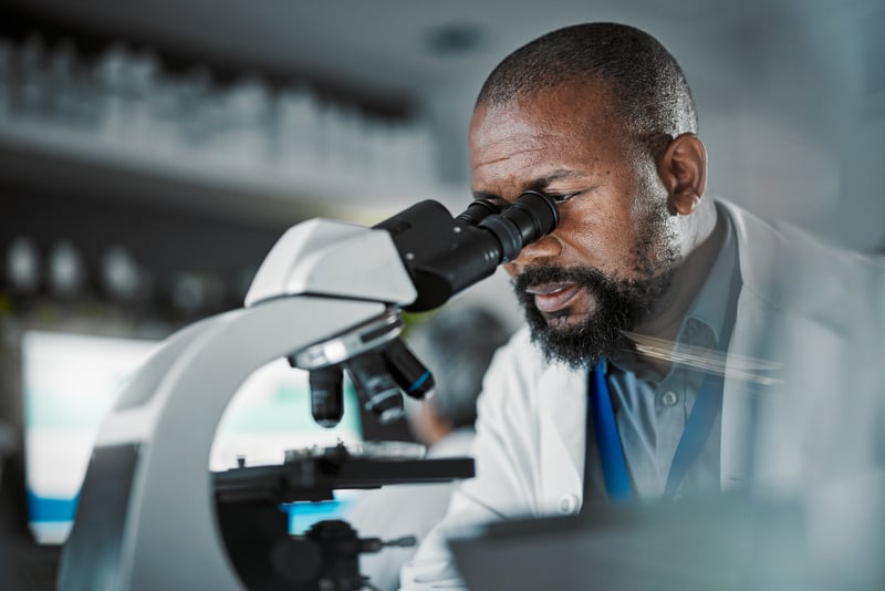 Researcher working at a microscope